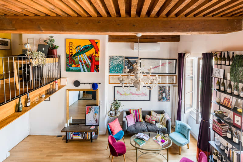 Living room with large framed pieces of artwork on a gallery wall.