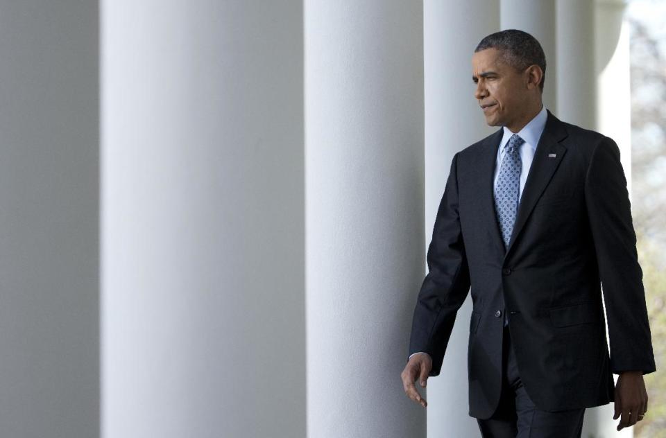 President Barack Obama walks from the Oval Office to the Rose Garden of the White House in Washington, Tuesday, April 1, 2014, to speak about the Affordable Care Act. (AP Photo/Manuel Balce Ceneta)