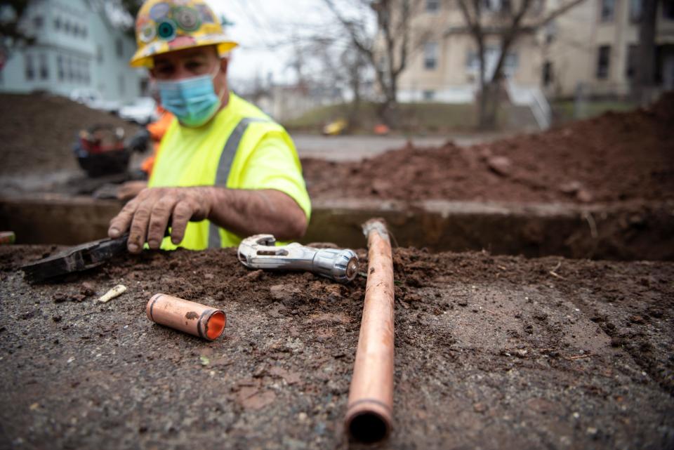 Worker replaces lead pipes with copper pipes on Sanford Avenue in Newark on March 24, 2021.