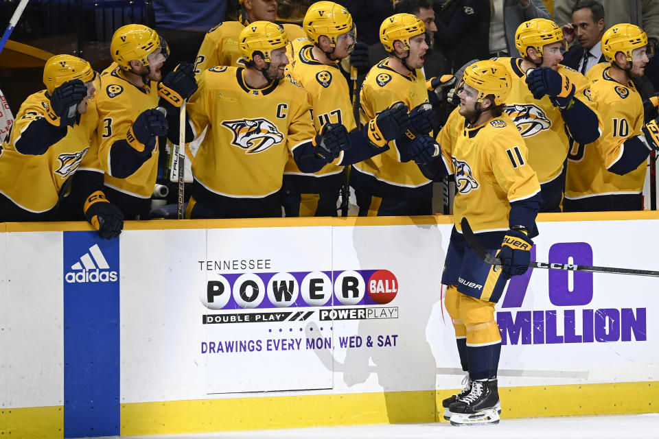 Nashville Predators left wing Samuel Fagemo (11) is congratulated after scoring a goal against the San Jose Sharks during the first period of an NHL hockey game Saturday, Oct. 21, 2023, in Nashville, Tenn. (AP Photo/Mark Zaleski)