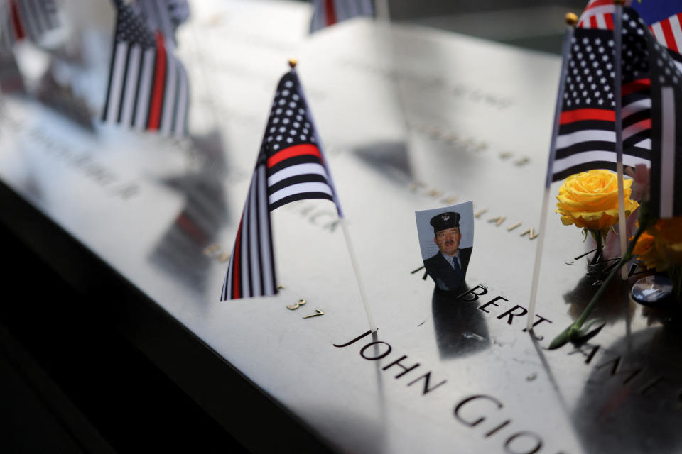 A picture is placed on the National September 11 Memorial & Museum, on the day of the 22nd anniversary of the September 11, 2001 attacks on the World Trade Center at the National September 11 Memorial & Museum, in New York City, U.S., September 11, 2023. REUTERS/Andrew Kelly
