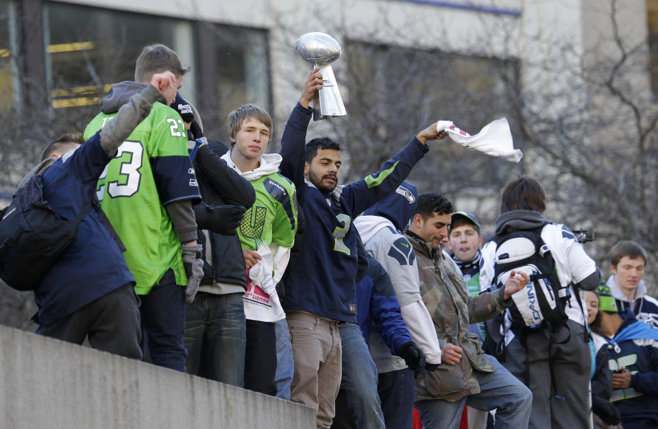 Seattle Seahawks fans watch during the Super Bowl champions parade on Wednesday, Feb. 5, 2014, in Seattle. The Seahawks beat the Denver Broncos 43-8 in NFL football's Super Bowl XLVIII on Sunday. (AP Photo/Ted S. Warren)