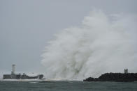 Surging waves hit against the breakwater and a lighthouse as Typhoon Hagibis approaches at a port in town of Kiho, Mie prefecture, central Japan Saturday, Oct. 12, 2019. Tokyo and surrounding areas braced for a powerful typhoon forecast as the worst in six decades, with streets and trains stations unusually quiet Saturday as rain poured over the city. (AP Photo/Toru Hanai)