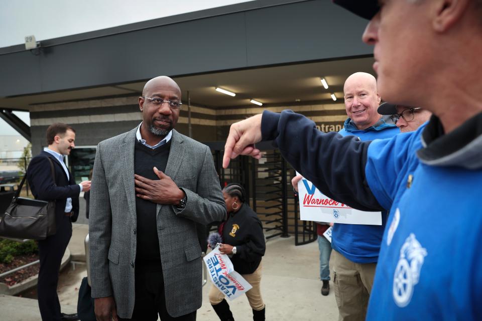 Georgia Democratic Senate candidate Raphael Warnock greets members of the Teamsters after speaking at a Get Out the Vote event at a UPS worksite 5 December 2022 in Atlanta, Georgia (Getty Images)