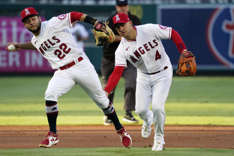 Los Angeles Angels second baseman David Fletcher, left, throws out Baltimore Orioles' Trey Mancini as shortstop Jose Iglesias backs him up during the first inning of a baseball game Saturday, July 3, 2021, in Anaheim, Calif. (AP Photo/Mark J. Terrill)