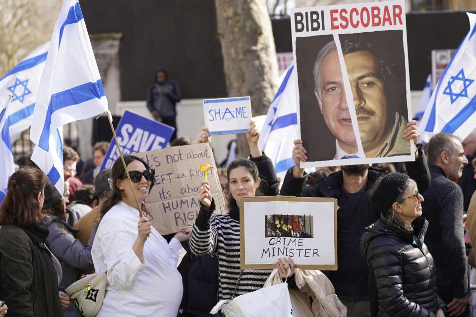 Demonstrators protest against Israeli Prime Minister Benjamin Netanyahu's visit, on Whitehall in London, Friday, March 24, 2023. British Prime Minister Rishi Sunak has welcomed Israeli leader Benjamin Netanyahu to his Downing Street office while demonstrators gathered nearby to protest Netanyahu's right-wing policies. (Stefan Rousseau/PA Wire/PA via AP)