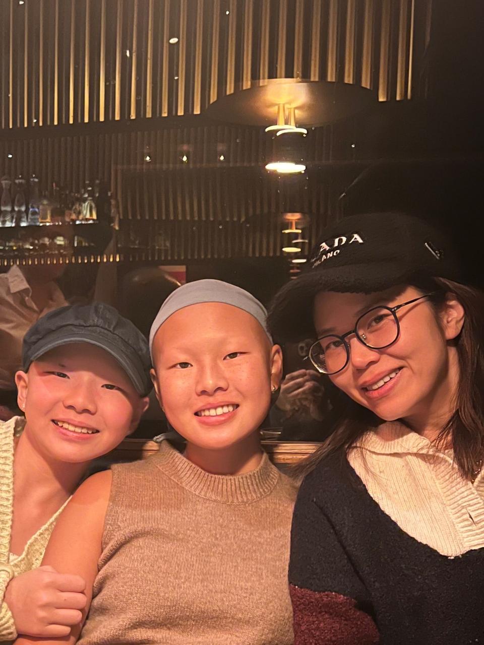 From left to right:  Madeline Lee, 13, her older sister Alison Lee, 17, and her mother Julie Yoo, 47.