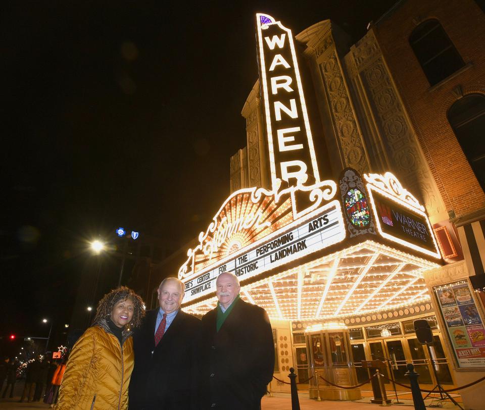With the Warner Theatre's new marquee in the background, from left, are: Gwendolyn White, chairman of the board of the Erie County Convention Center Authority, the governing body of Visit Erie, which oversees the Warner Theatre, Thomas B. Hagen, chairman of the board of Erie Insurance, and Casey Wells, executive director of Visit Erie.