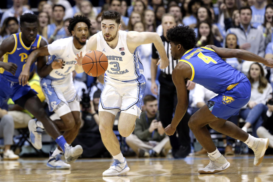 North Carolina guard Andrew Platek (3) dribbles against Pittsburgh guard Gerald Drumgoole Jr. (4) during the first half of an NCAA college basketball game in Chapel Hill, N.C., Wednesday, Jan. 8, 2020. (AP Photo/Gerry Broome)