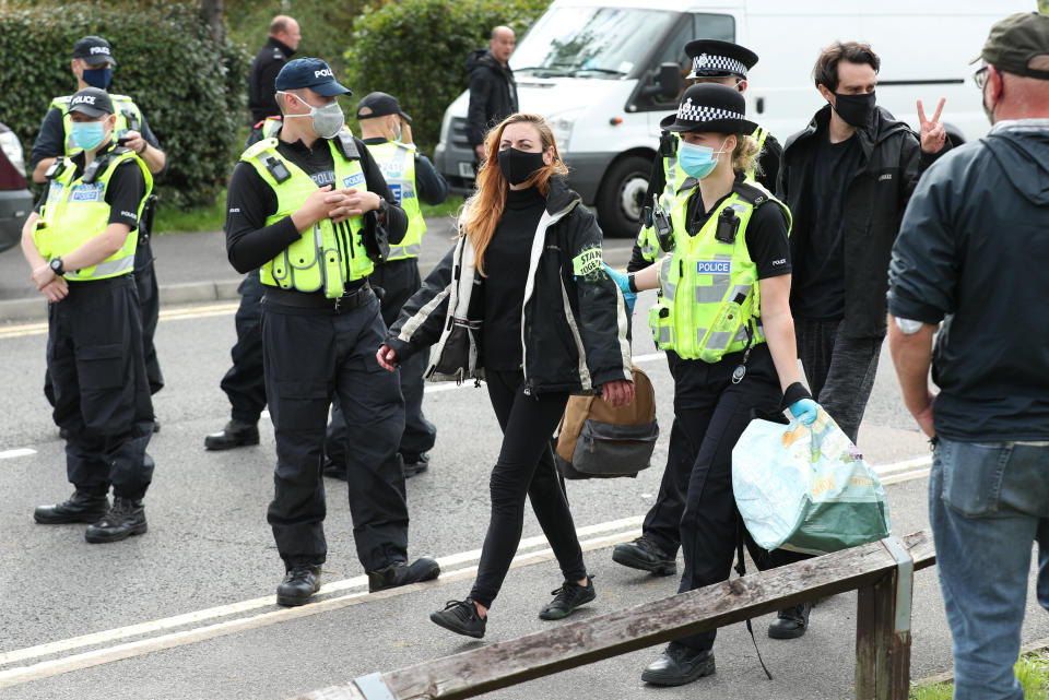 One protester is lead away by police outside the Newsprinters printing works at Broxbourne, Hertfordshire, other protesters use bamboo lock-ons and a van to continue to block the road. (Photo by Yui Mok/PA Images via Getty Images)