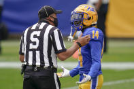 FILE - In this Saturday, Oct,. 3, 2020, file photo, Pittsburgh Panthers defensive back Jason Pinnock (15) talks with official Jim Corpora after a pass interference penalty in the first half of an NCAA college football game against North Carolina State, in Pittsburgh. N.C. State beat Pitt 30-29. Pitt entered October unbeaten. Reality has come quickly. (AP Photo/Keith Srakocic, File)