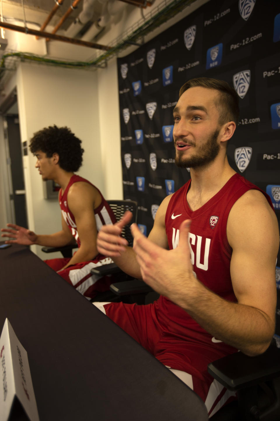 Washington State's CJ Elleby, left, and Jeff Pollard speak during the Pac-12 NCAA college basketball media day Tuesday, Oct. 8, 2019 in San Francisco. (AP Photo/D. Ross Cameron)