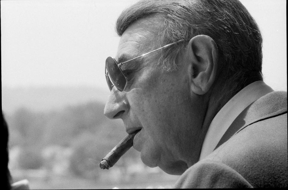 ABC sportscaster Howard Cosell puffed on a cigar as he watched the day’s races at Churchill Downs on Derby day. May 5, 1984.