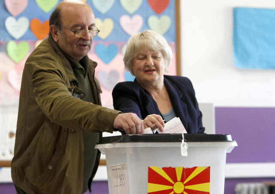 A couple cast their ballots for the presidential election at a polling station in Skopje, North Macedonia, Sunday, April 21, 2019. Polls were opened early on Sunday in North Macedonia for presidential elections seen as key test of the government following deep polarization after the country changed its name to end a decades-old dispute with neighboring Greece over the use of the term "Macedonia". (AP Photo/Boris Grdanoski)