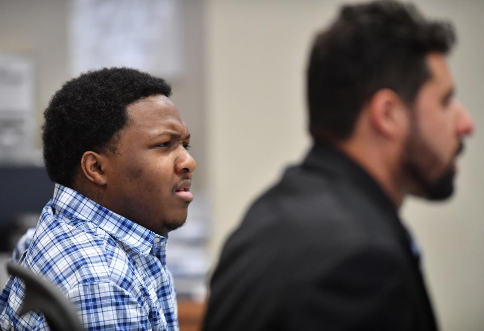 Nyquan Priester, left, sitting with his defense attorney, Omar Abdelghany, reacts to witness testimony Tuesday morning in court. Priester has been charged with 2nd degree murder in connection with a shooting at Ackerman Park in December 2021.