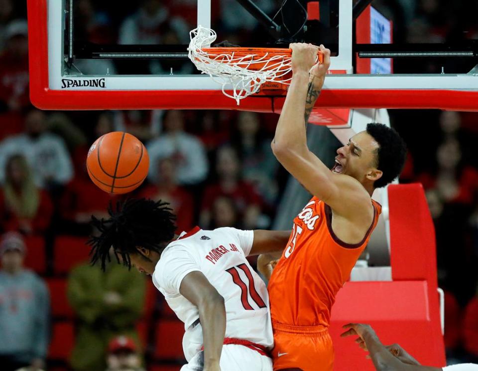 Virginia Tech’s Lynn Kidd dunks over N.C. State’s Dennis Parker Jr. during the second half of the Wolfpack’s 84-78 loss on Saturday, Jan. 20, 2024, at PNC Arena in Raleigh, N.C.