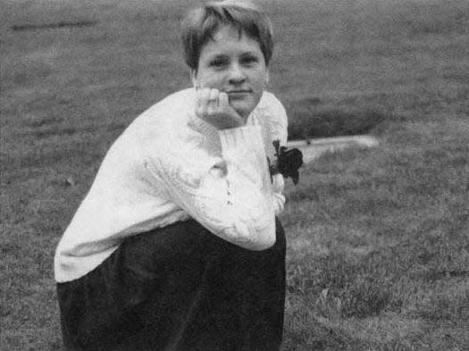 Hayley Klein kneels beside the grave of her mom