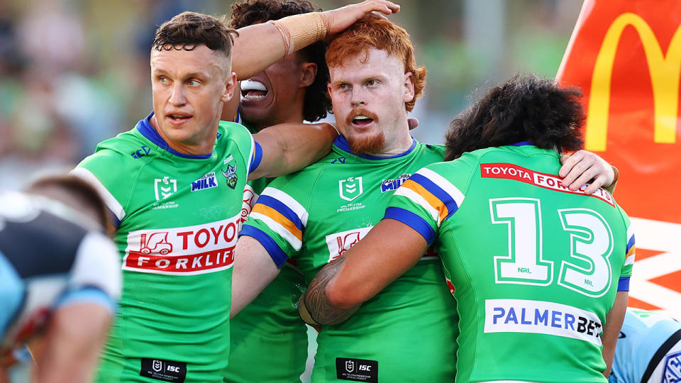 Canberra Raiders players celebrate a try being scored.