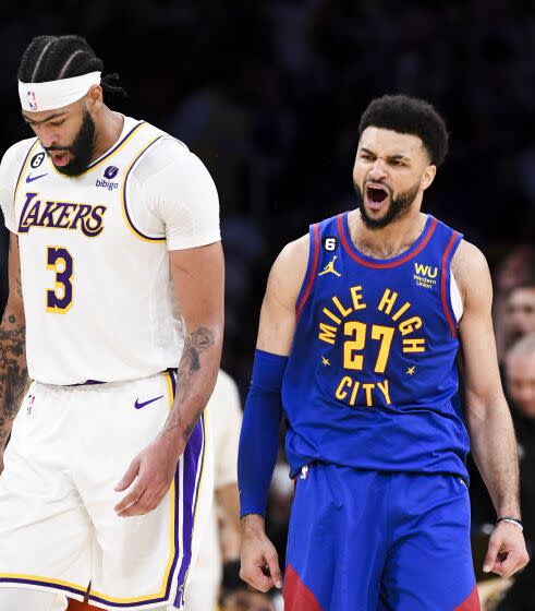 Nuggets guard Jamal Murray (27) celebrates after making a three-point shot against Anthony Davis (3) and the Lakers in Game 3