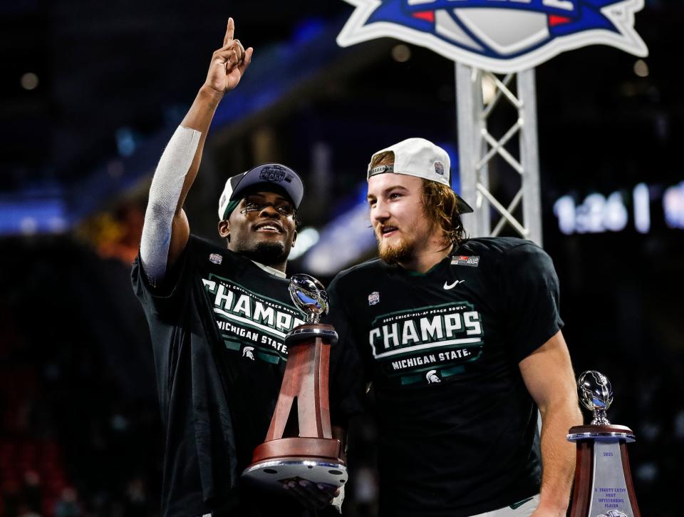 Michigan State wide receiver Jayden Reed, left, named Peach Bowl offensive player MVP, stands next to linebacker Cal Haladay after the 31-21 win over Pittsburgh in the Peach Bowl at the Mercedes-Benz Stadium in Atlanta on Thursday, Dec. 30, 2021.