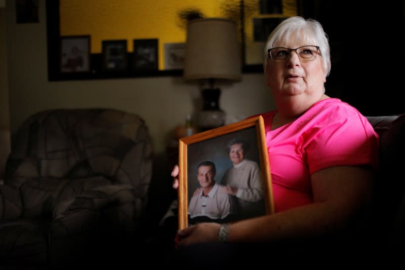 Debbie de los Angeles, whose mother died from coronavirus disease, poses for a portrait at her home in Monroe