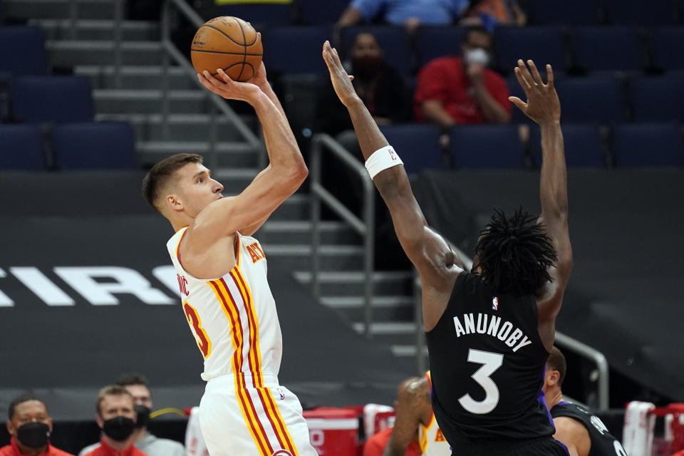 Atlanta Hawks guard Bogdan Bogdanovic (13) shoots over Toronto Raptors forward OG Anunoby (3) during the first half of an NBA basketball game Tuesday, April 13, 2021, in Tampa, Fla. (AP Photo/Chris O'Meara)