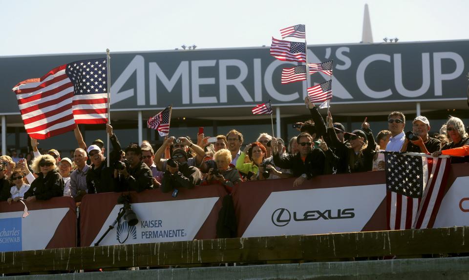 Fans of Oracle Team USA cheer after their team defeated Emirates Team New Zealand during Race 18 of the 34th America's Cup yacht sailing race in San Francisco, California