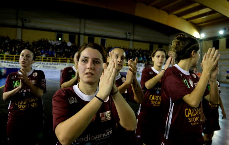 Sporting Locri's players applaud and greet supporters after the women's futsal match between Sporting Locri and Lazio on January 10, 2016 at the Sport Centre in Locri, southern Italy