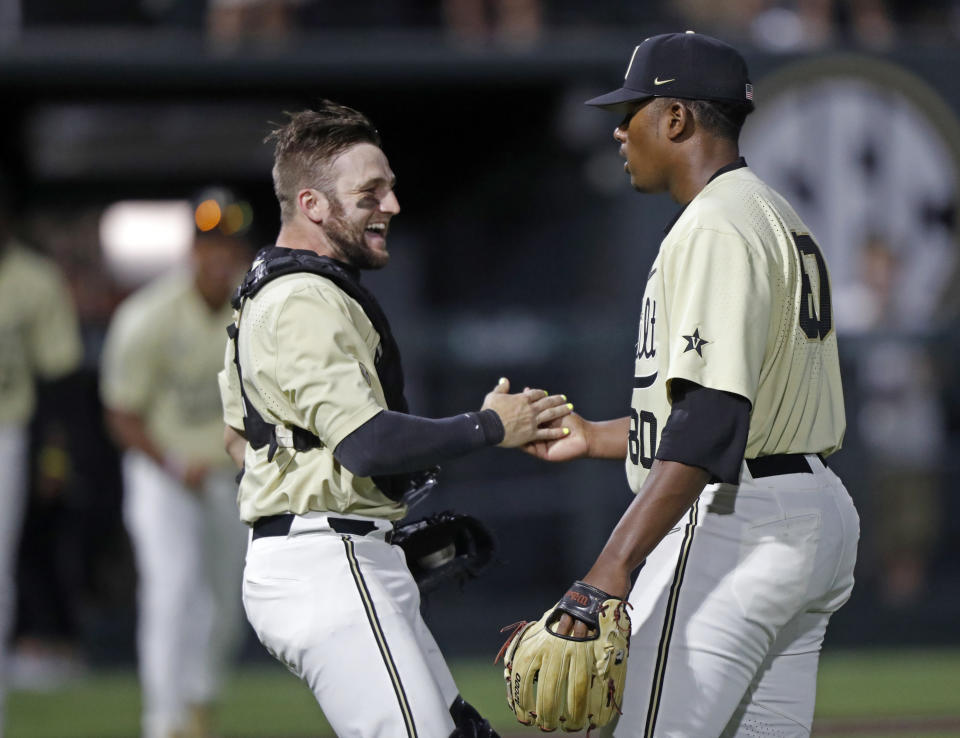 Vanderbilt's Kumar Rocker (80) is congratulated by catcher Philip Clarke (5) after Rocker threw a no-hitter against Duke in an NCAA college baseball tournament super regional game Saturday, June 8, 2019, in Nashville, Tenn. Vanderbilt won 3-0. (AP Photo/Wade Payne)