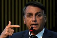 Brazil's President Jair Bolsonaro speaks during a ceremony at the Ministry of Citizenship, in Brasilia, Brazil, Monday, Aug. 2, 2021. Bolsonaro once again mentioned in his speech the existence of fraud in the Brazilian electoral system. The electoral court has rebuffed his claims as baseless, saying the system is trustworthy and there are several means of checking results. (AP Photo/Eraldo Peres)