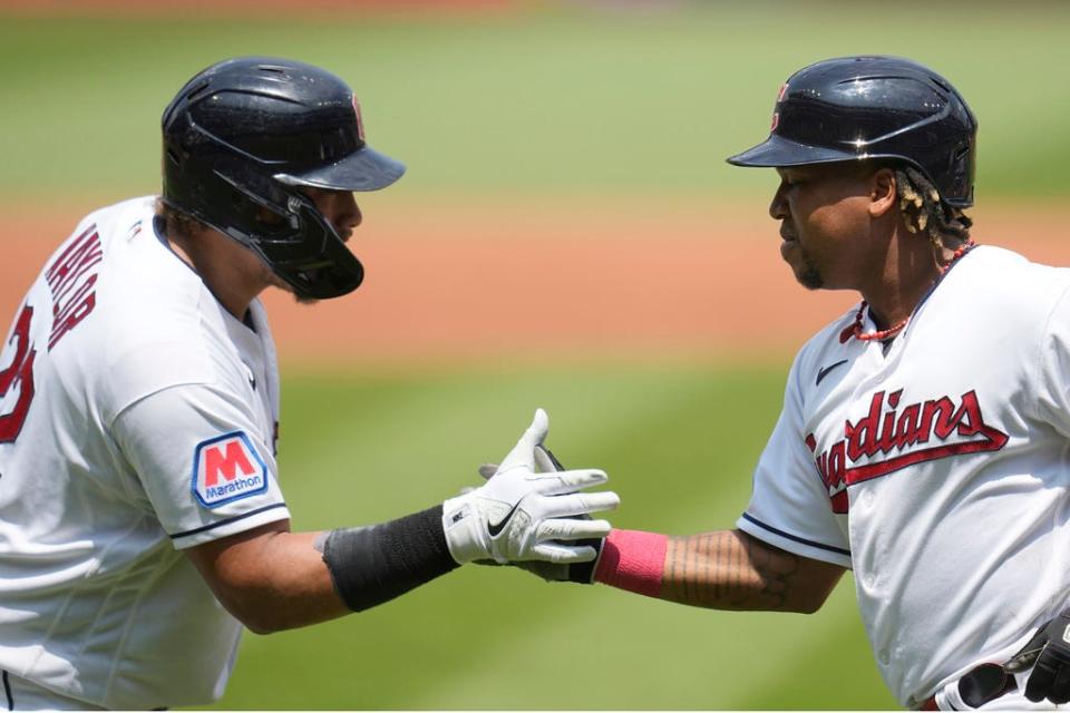 Cleveland Guardians' Josh Naylor, left, congratulates Jose Ramirez, right, after Ramirez's home run in the second inning July 26 against the Kansas City Royals in Cleveland.