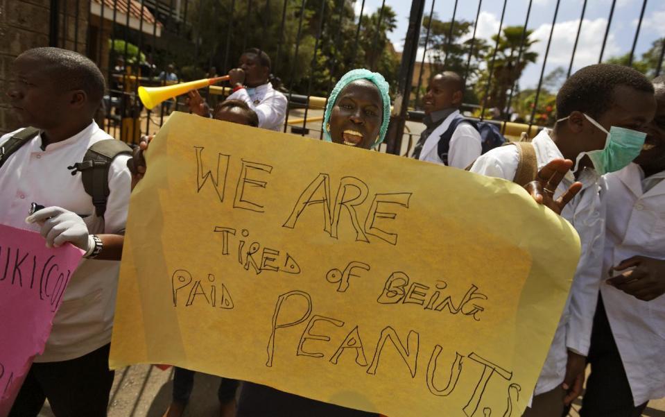 FILE - In this Thursday, Dec. 8, 2016 file photo, Kenyan nurses and other health-workers on strike demonstrate over low pay at Uhuru Park in downtown Nairobi, Kenya. A Kenyan judge Monday, Feb. 13, 2017 has jailed seven officials of the medics union for failing to call off a two-month strike by doctors at public hospitals that has seen at least a dozen die due to lack of medical care. (AP Photo/Ben Curtis, File)