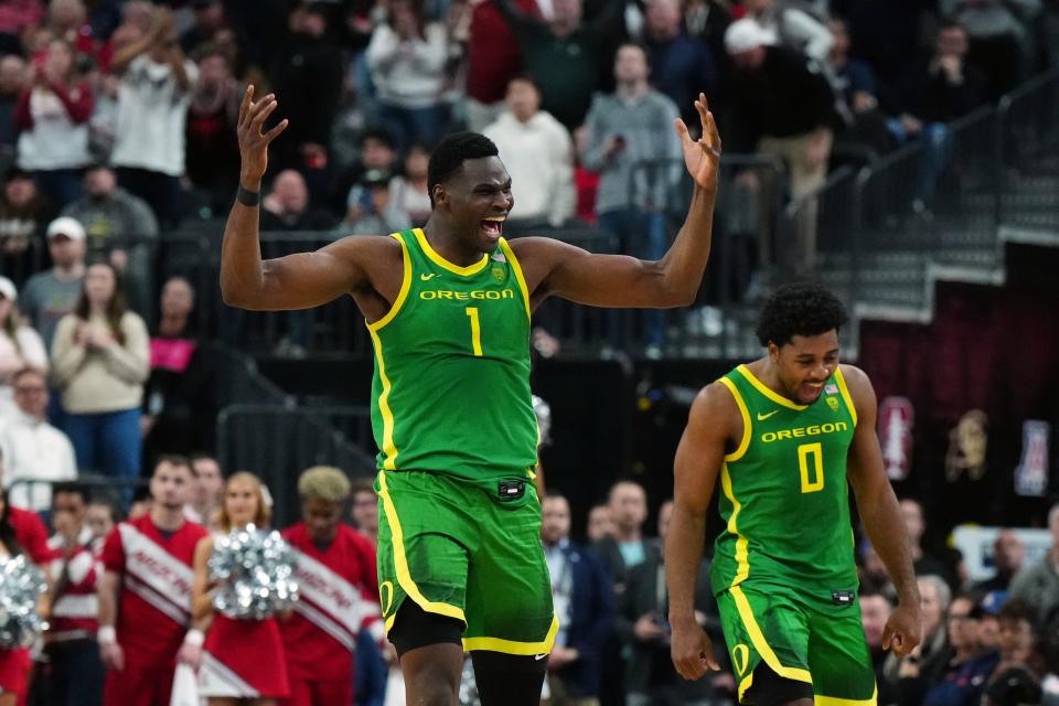 Mar 15, 2024; Las Vegas, NV, USA; Oregon Ducks center N'Faly Dante (1) and guard Kario Oquendo (0) celebrate against the Arizona Wildcats in the second half at T-Mobile Arena. Mandatory Credit: Kirby Lee-USA TODAY Sports