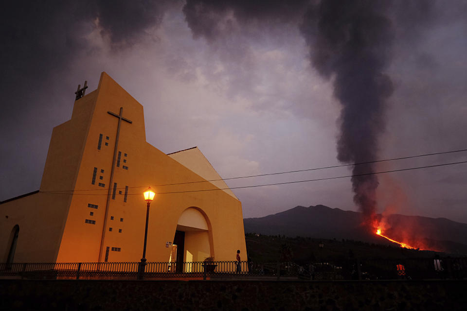 Lava flows from a volcano on the Canary island of La Palma, Spain on Monday Sept. 27, 2021. A Spanish island volcano that has buried more than 500 buildings and displaced over 6,000 people since last week lessened its activity on Monday, although scientists warned that it was too early to declare the eruption phase finished and authorities ordered residents to stay indoors to avoid the unhealthy fumes from lava meeting sea waters. (AP Photo/Daniel Roca)