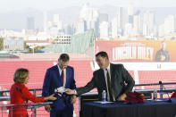 University of Southern California President Carol L. Folt, left, and Athletic Director Mike Bohn, right, introduce the new head football coach, Lincoln Riley, in Los Angeles, Monday, Nov. 29, 2021. (AP Photo/Ashley Landis)