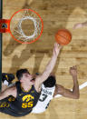 Iowa's Luka Garza, left, reaches for a rebound over Michigan State's Xavier Tillman during the second half of an NCAA college basketball game, Tuesday, Feb. 25, 2020, in East Lansing, Mich. Michigan State won 78-70. (AP Photo/Al Goldis)