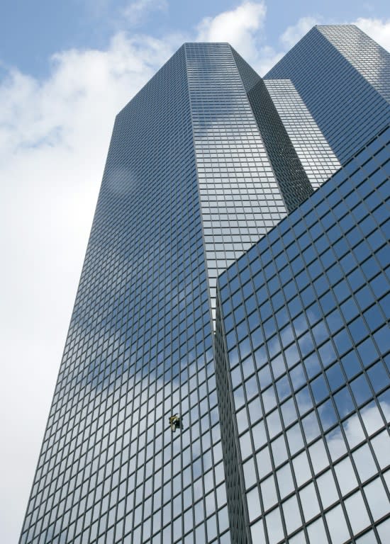 French urban climber Alain Robert, nicknamed "Spiderman", scales a building in Paris's La Defense business district on March 21, 2016