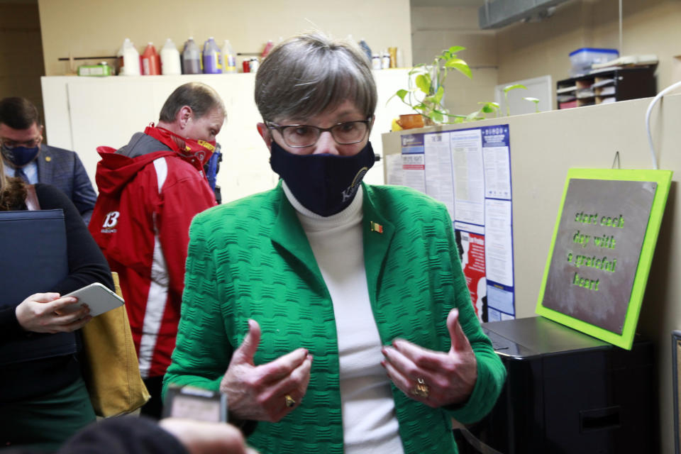 Kansas Gov. Laura Kelly answers questions from reporters following a tour of a childcare center, Wednesday, March 17, 2021, in Topeka, Kan. The Democratic governor calls a Republican proposal to ban transgender athletes from girls' and women's school sports "regressive." (AP Photo/John Hanna)