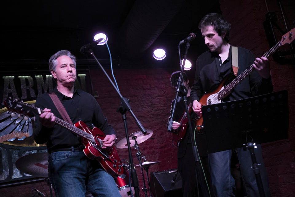 US Secretary of State Antony Blinken, left, performs "Rockin' in the Free World" with members of The 1999 band at the Barman Dictat bar in Kyiv, Tuesday, May 14, 2024. Blinken sought Tuesday to rally the spirits of glum Ukrainians facing a fierce new Russian offensive, assuring them that they are not alone and that billions of dollars in American military aid on its way to the country would make a “real difference” on the battlefield. (Brendan Smialowski/Pool photo via AP)