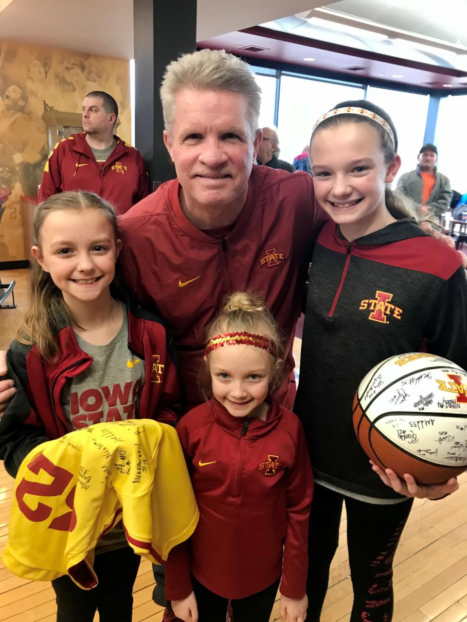 Mia Schwieso, left, and sisters Kendall, bottom, and Aubrey meet Iowa State coach Bill Fennelly.