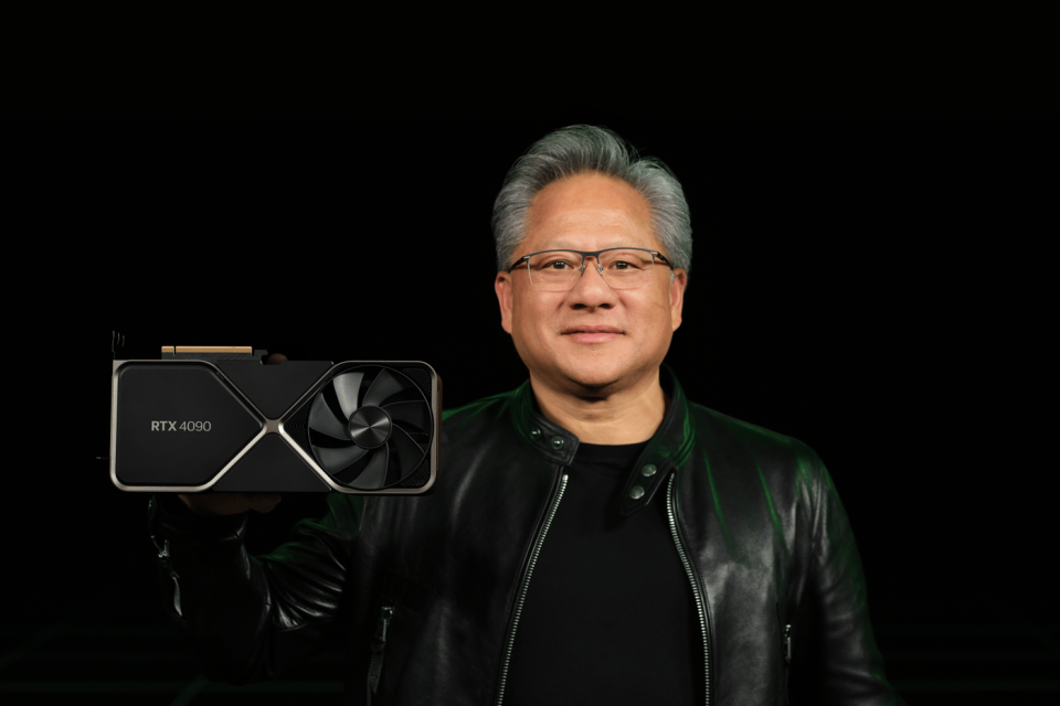 Nvidia's CEO Jensen Huang holds up an RTX 4090 GPU.