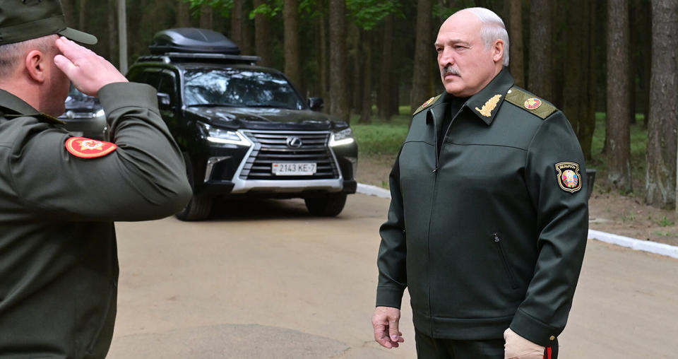 In this handout photo released by Belarus' Presidential Press Office, Belarusian President Alexander Lukashenko listens to an officer's report as he arrives to visit the Central Command Post of the Air Force and Air Defense Forces in Belarus, Monday, May 15, 2023. (Belarus' Presidential Press Office via AP)