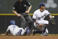 Jul 21, 2018; Milwaukee, WI, USA; Los Angeles Dodgers right fielder Matt Kemp (27) slides into second base with a double as Milwaukee Brewers shortstop Tyler Saladino (13) fields the ball in the seventh inning at Miller Park. Mandatory Credit: Benny Sieu-USA TODAY Sports