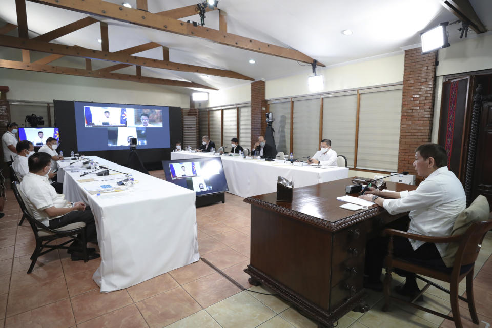 In this photo provided by the Malacanang Presidential Photographers Division, Philippine President Rodrigo Duterte, right, presides over a meeting with the Inter-Agency Task Force on the Emerging Infectious Diseases (IATF-EID) core members at the Malacanang presidential palace in Manila, Philippines Wednesday, May 5, 2021. The Philippine president has asked China to get back 1,000 doses of donated Sinopharm vaccine after facing criticisms for allowing himself to be injected with it although it has not yet been authorized for public use in the country. (Alberto Alcain/Malacanang Presidential Photographers Division via AP)