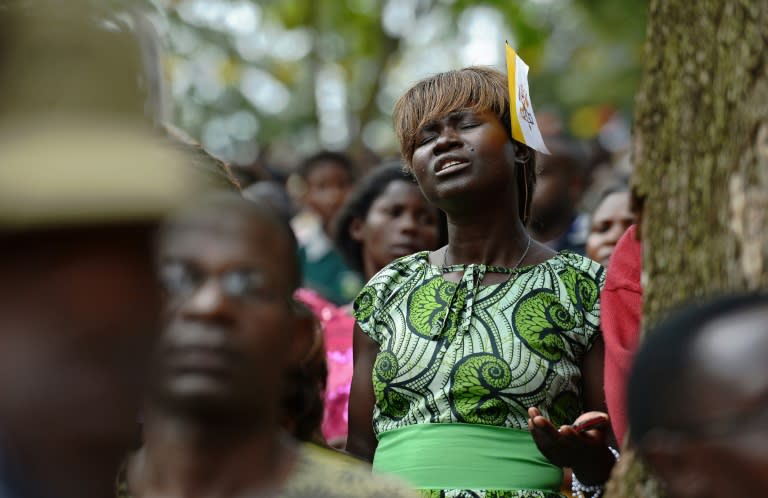 A woman prays at the Namugongo Martyrs' Shrine during an open air mass held by Pope Francis on November 28, 2015