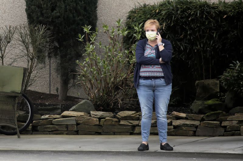 Woman talks on the phone at the Life Care Center of Kirkland, the long-term care facility linked to several confirmed coronavirus cases in the state, in Kirkland