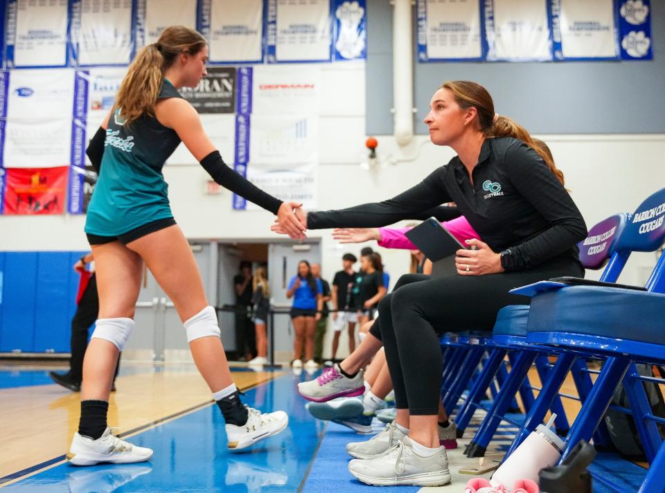 Gulf Coast assistant coach Snowy Stokes (right) high-fives senior Ashlyn Callan (left) in the CCAC Championship game against Barron Collier on Thursday, Oct. 5, 2023.