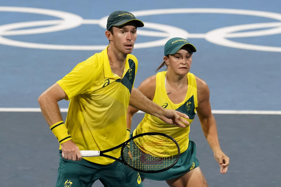 John Peers, left, and Ashleigh Barty, of Australia, prepare to return to Maria Sakkari and Stefanos Tsitsipas, of Greece, during a mixed doubles quarterfinal tennis match at the 2020 Summer Olympics, Thursday, July 29, 2021, in Tokyo, Japan. (AP Photo/Patrick Semansky)