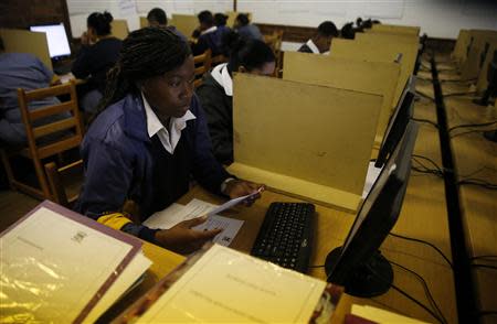 Students use computers to study at Elswood Secondary School in Cape Town November 7, 2013. REUTERS/Mike Hutchings