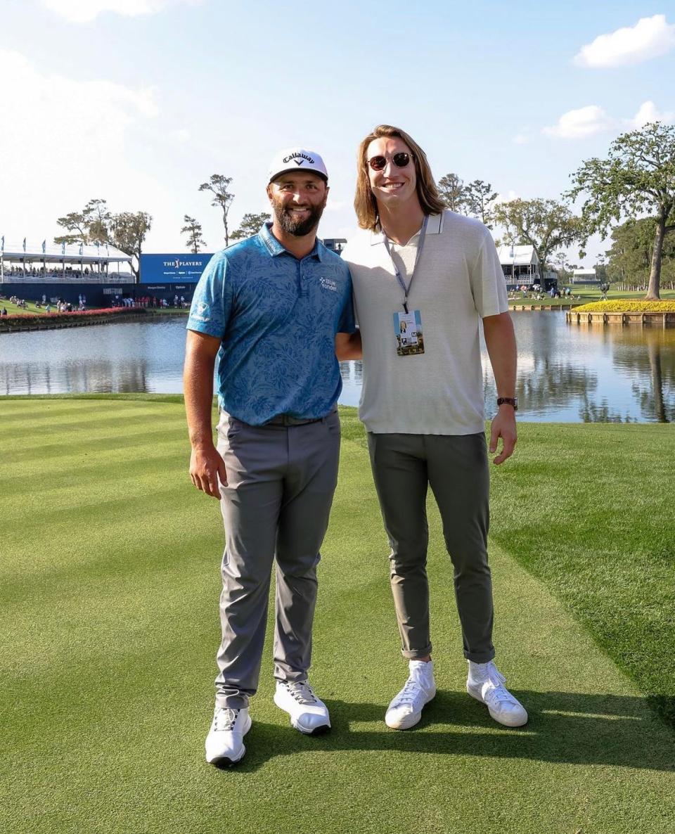 Jaguars quarterback Trevor Lawrence poses with Jon Rahm near the 17th hole of the Players Stadium Course at TPC Sawgrass last March during a practice round for The Players Championship.